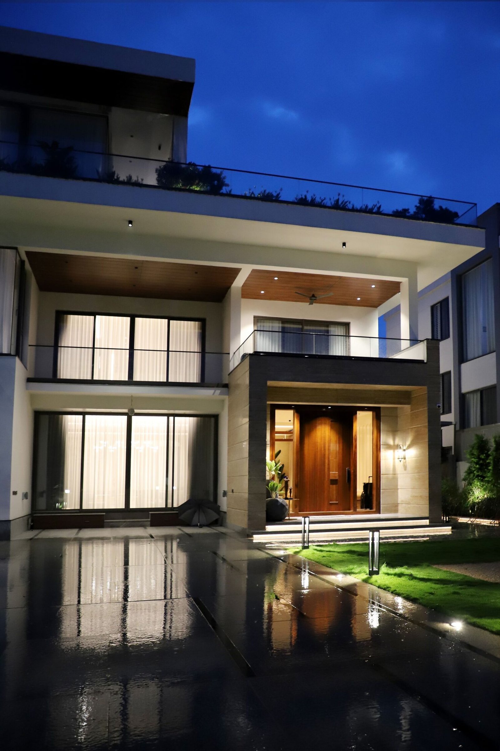 Modern luxury house exterior illuminated at night